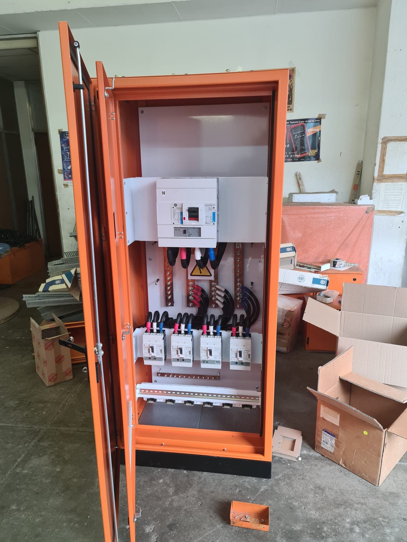 Open commercial distribution board showing breakers and cabling