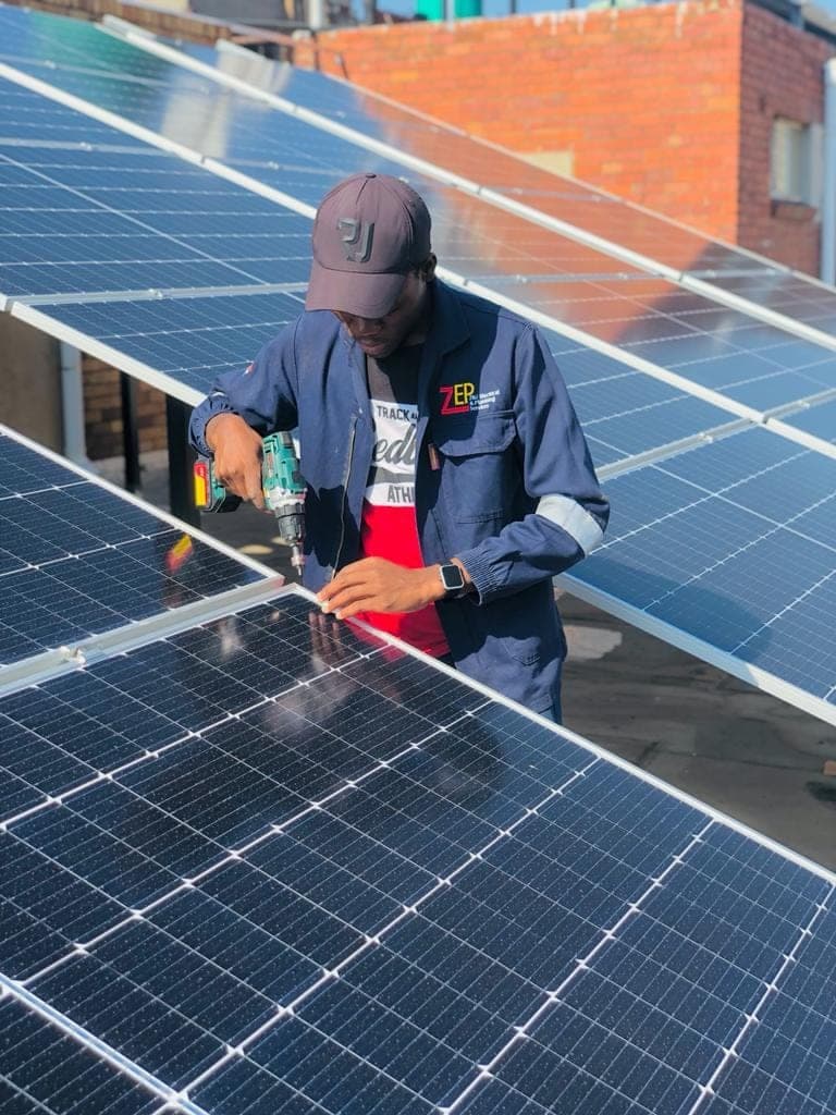 ZEPS technician fastening solar panels on a Johannesburg roof