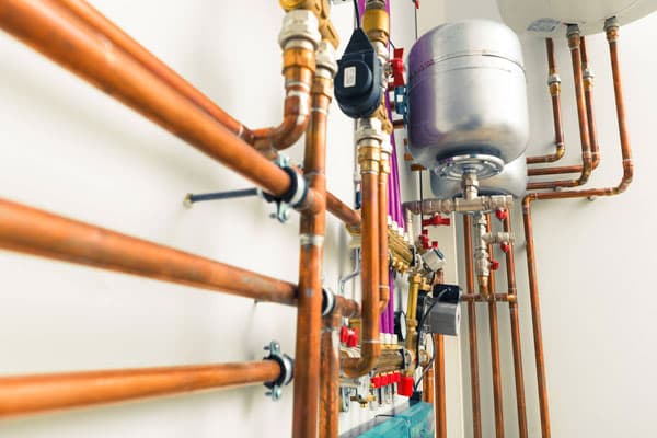 Neat copper pipework and a water heating installation