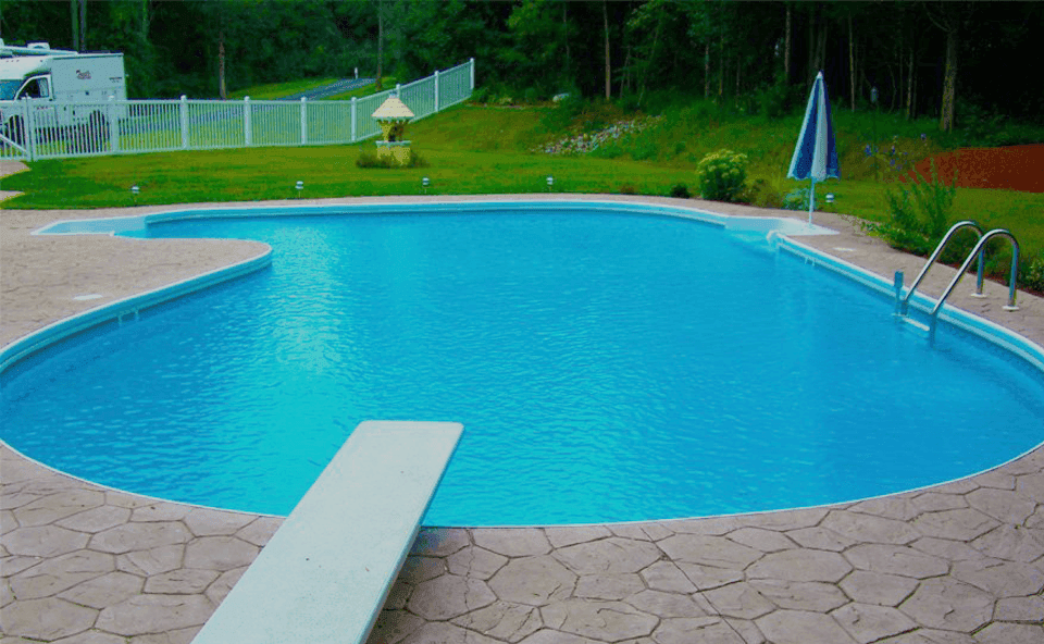 Residential swimming pool with a clean deck and ladder