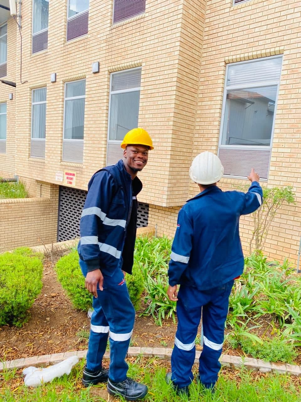 Two ZEPS technicians in hard hats at a Johannesburg building