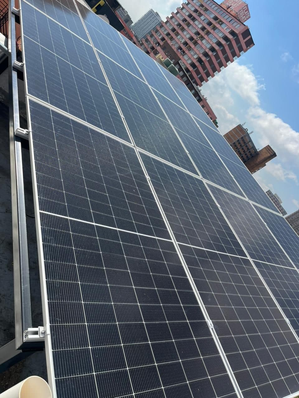 Urban rooftop solar array against Johannesburg flats